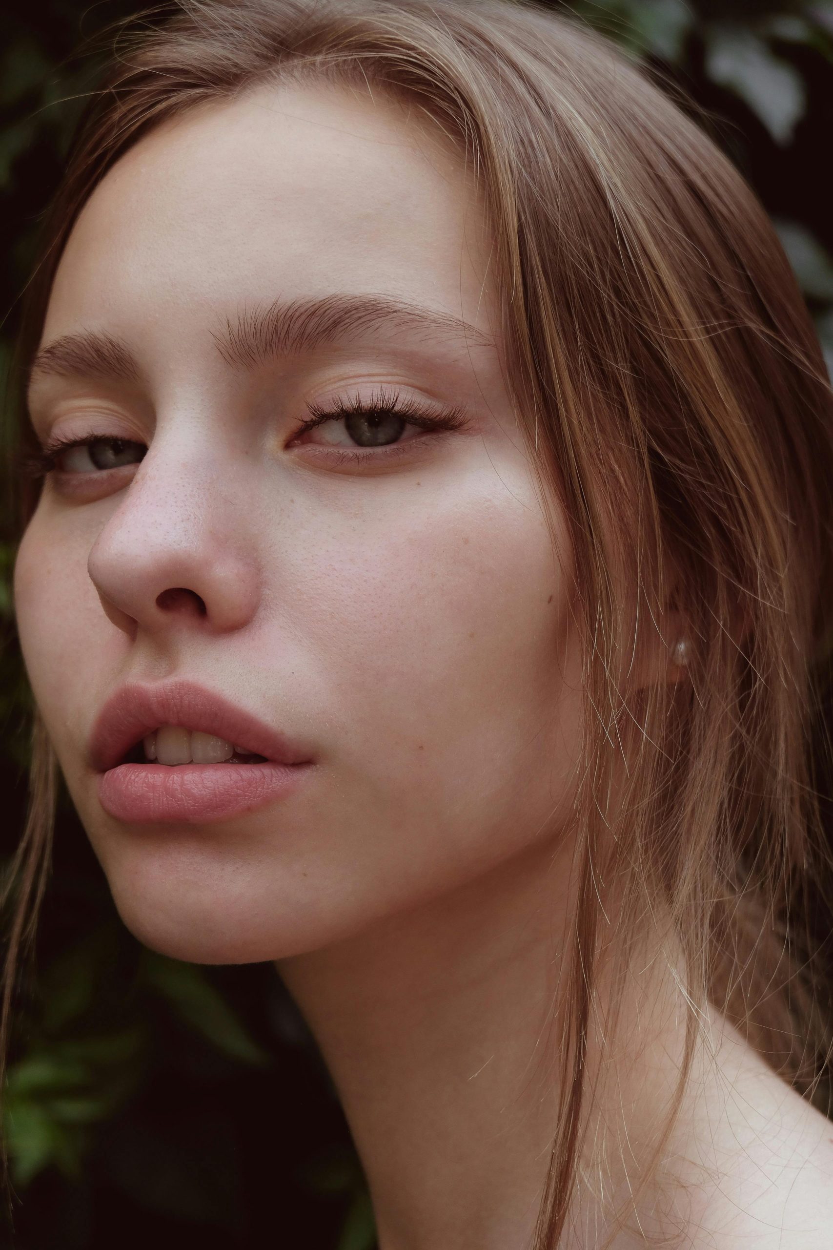 Close-up portrait of a young woman with natural beauty and striking expression.